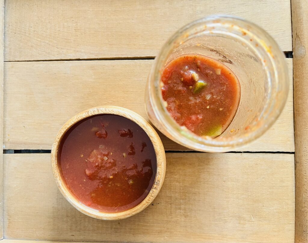 salsa in a wooden bowl and a jar