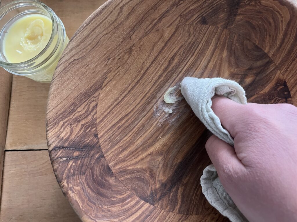 rubbing the wood conditioner into a wooden bowl