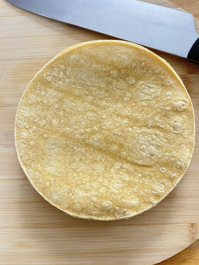 corn tortillas stacked up to be cut