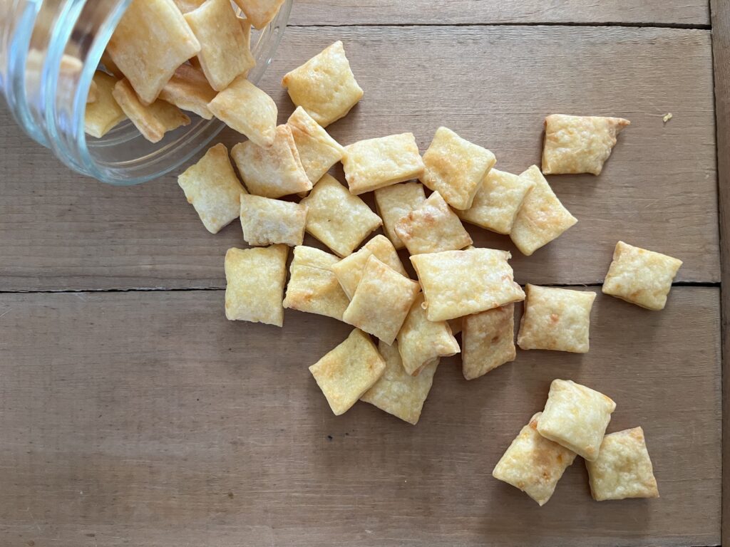 homemade cheez it crackers on a wooden board