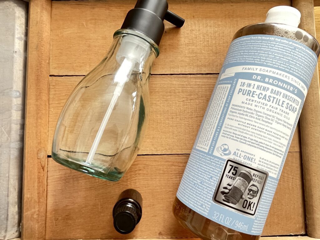 liquid castile soap, a foaming hand soap dispenser and some essential oils