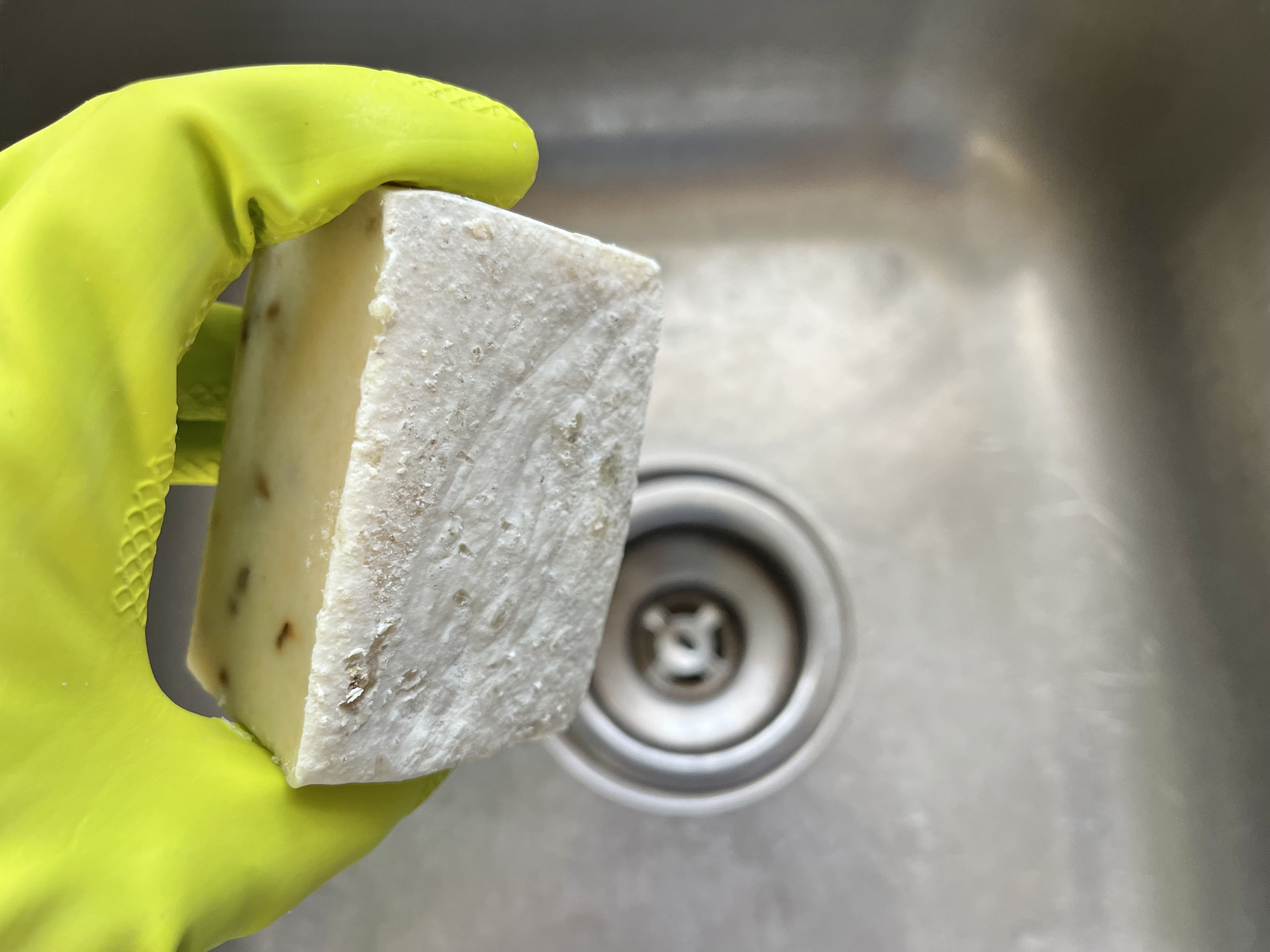 holding a bar of soap that the soda ash needs removed