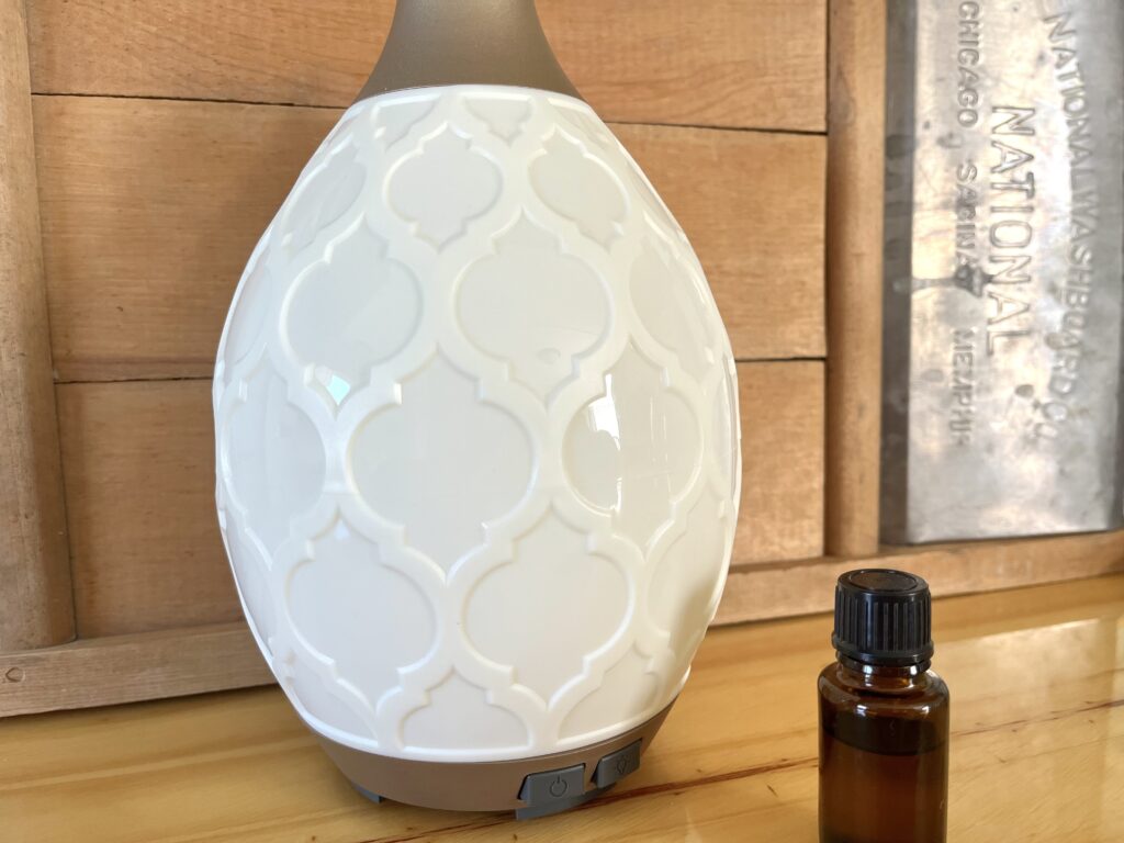 a diffuser beside some essential oils