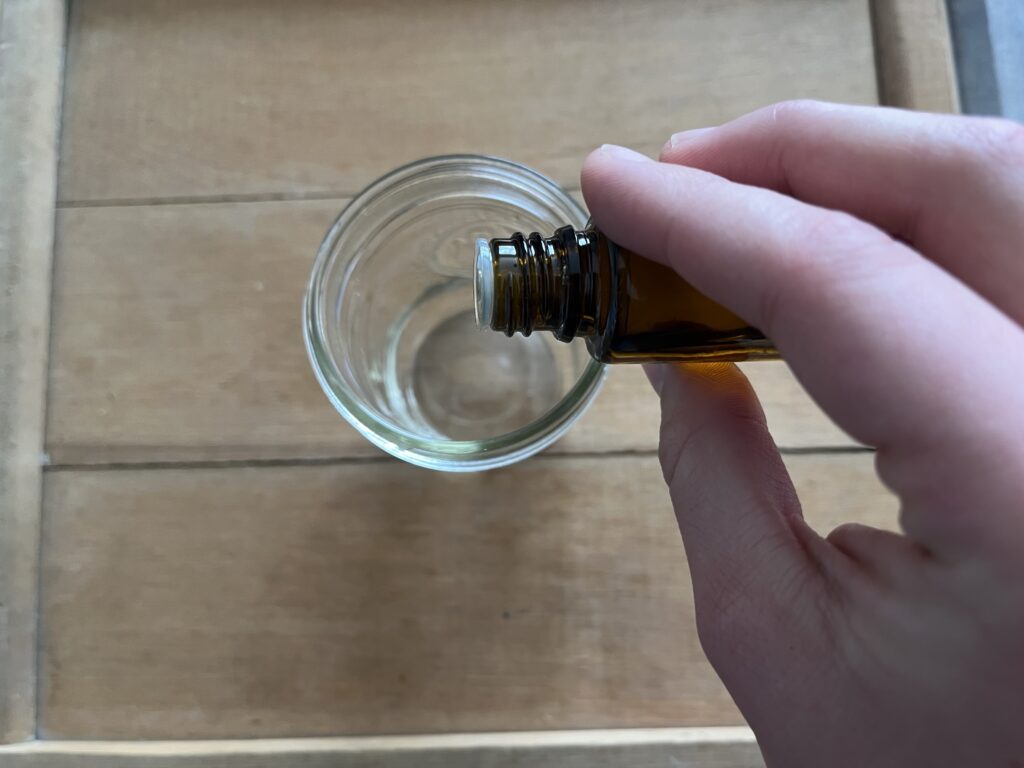 dropping essential oils into a jar